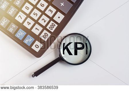Kpi Key Performance Indicator Text Acronym Word Throgh Magnifying Glass Lens On Office Desk Table. B