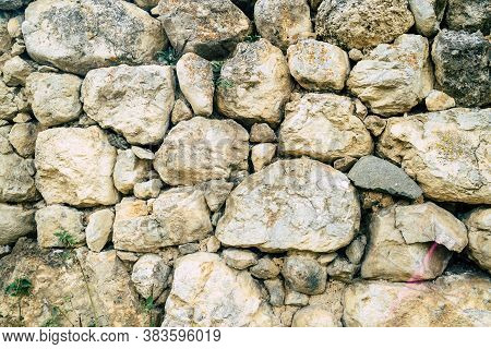 Texture Of Old Stones Of Various Forms With Seams. Close Up Of Shabby Masonry. Stone Wall From Uneve