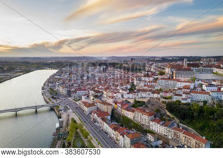 Coimbra Drone Aerial City View At Sunset With Mondego River And Beautiful Historic Buildings, In Por