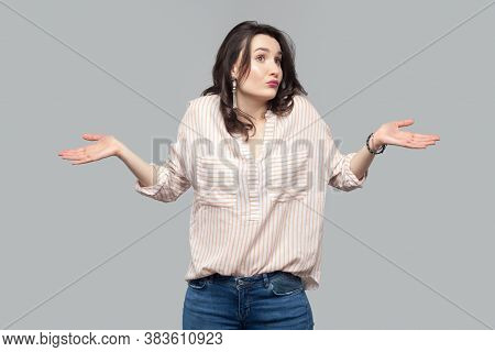 I Don't Know. Portrait Of Thoughtful Beautiful Attractive Brunette Woman In Casual Striped Orange Sh
