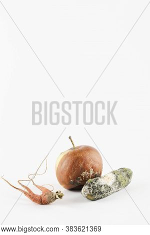 Rotten Apple, Cucumber, Carrot On White Background. Global Hunger Problem. Overconsumption Concept. 