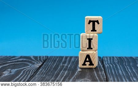 Concept Word Tia (transient Ischemic Attack) On Wooden Cubes On A Blue Background. Medical Oncept