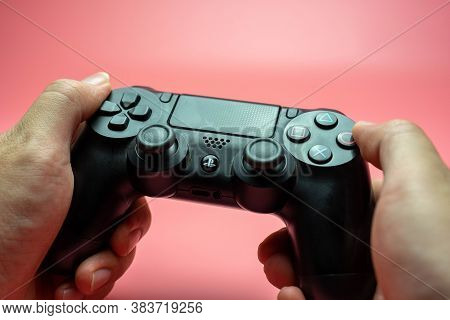 Bangkok, Thailand - September 12, 2019: Male Hands Holding A Ps4 Controller, Sony Playstation 4 Game