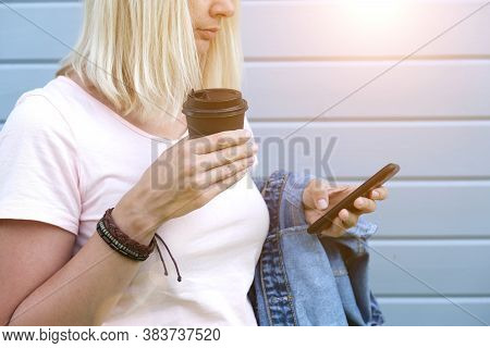 Hippie Woman Wearing Boho Leather Bracelets On A Wrist Holding A Takeaway Paper Cup Of Coffee And A 
