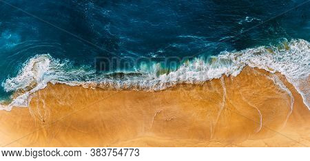 Beautiful Sandy Beach, Top View. Panoramic View Of The Sandy Beach. The Sea Wave Rolls On The Shore.