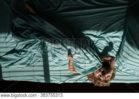 Top View Of Child Sleeping Cozily On A Bed In Bedroom At Morning. Kids Little Boy Sleeps On Pillow