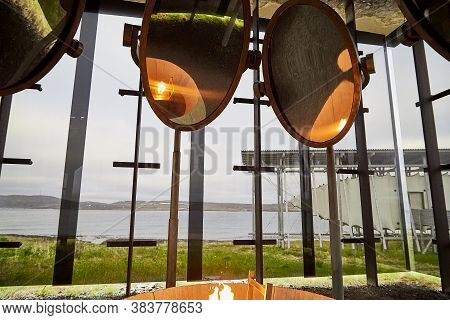 Vardo, Norway - 23 June 2019: Stylized Bonfire And Mirrors In A Black Cubic Building With Glass In T