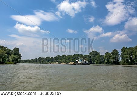 Novi Becej, Tisa River, Serbia, May 14, 2017. A Large And Powerful River Boat Pushes Barges Loaded W