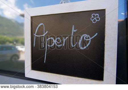 Aperto (open) Inscription Draw On A Blackboard And Hanging In Front Of A Bistro In Riva San Vitale, 