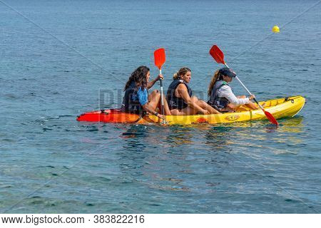 Sant Feliu De Guixols, Spain : 02 Sept 2020: Three Young Girls Go Kayaking In The  Village Of Sant F