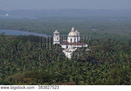 OLD GOA, INDIA - FEBRUARY 18, 2020: Old Goa, Mandovi River and Church of St Cajetan, Goa, India
