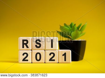 Rsi - Business Financial Concept On A Yellow Background. Wooden Cubes And Flower In A Pot.