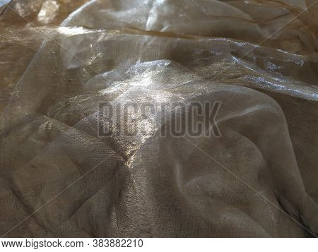 Organza Is Yellow-brown With A Beige Sheen. Shiny, Reflective, Beautiful Fabric For Curtains, Tulles
