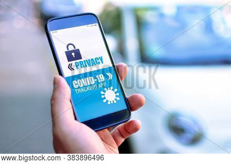 Privacy Concerns With Corona Virus Tracking App Concept Showing Hand Holding Cell Phone With Applica