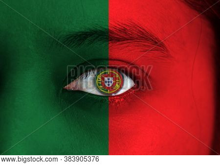 Human Face Painted Portuguese Flag With Coat Of Arms Of Portugal On The Center Of Eye Or Eyeball. Hu