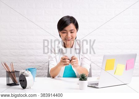 Happy Woman Use Smart Phone At Office
