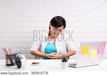 Woman Has Stomachache At Office