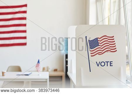 Background Image Of Voting Booths Decorated With American Flags At Empty Polling Station, Copy Space