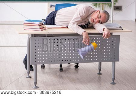 Old male teacher in the classroom