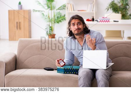 Young man doing marriage proposal via internet