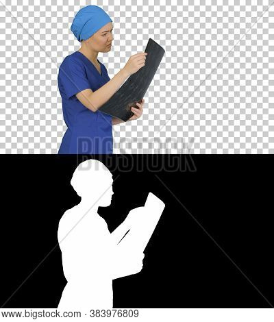 Serious Female Doctor Looking At Mri Scan Of Brain, Alpha Channe