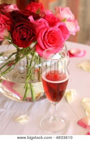 Bouquet Of Roses And Glass Of Champagne