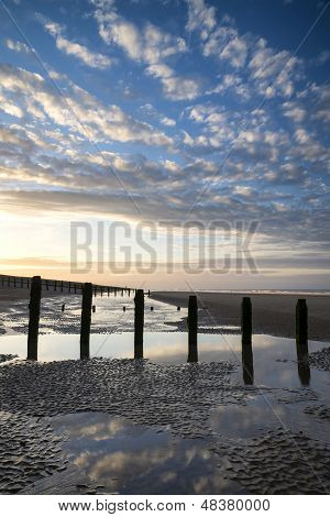 Vibrant Sunrise Landscape Reflected In Low Tide Water On Beach