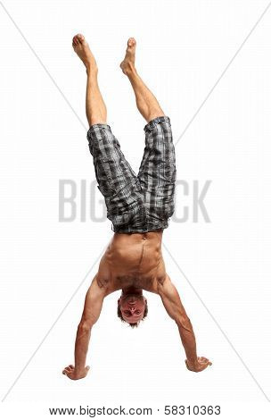 Young muscular man handwalking over white