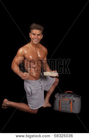 Man No Shirt Shiny Kneel By Bag Food