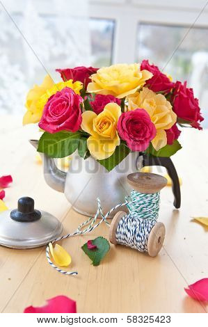 Colorful Roses In A Tea Can
