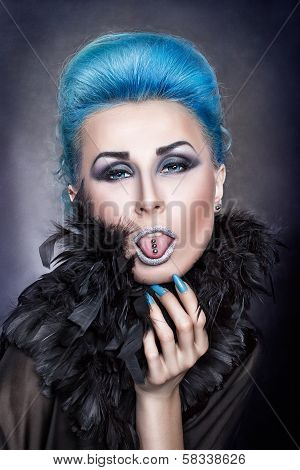 Girl With Blue Hair Shows A Pierced Tongue.