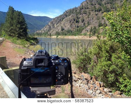 A Dslr Taking A Photo Of A Wide Mountain River - Clark Fork River Montana Usa