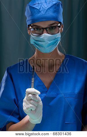 Portrait Of A Female Surgeon Holding Surgical Scalpel