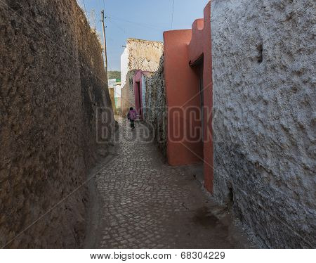 Harar. Ethiopia - December 23, 2013: Young Boy Running As He Is Late For School In Narrow Alleyway O