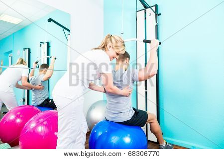 Patient at the physiotherapy doing physical exercises with therapist in sport rehabilitation