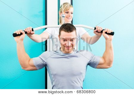 Patient at the physiotherapy doing physical exercises with therapist in sport rehabilitation
