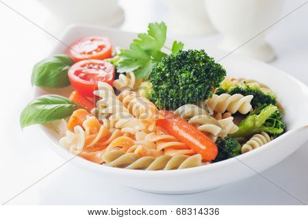 Italian pasta primavera with broccoli and baby carrot