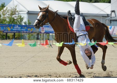 LYTKARINO, MOSCOW REGION, RUSSIA - JULY 12, 2014: Natalya Petrusinskaya performs stunt during Russian championship in trick riding. Lytkarino housed the Russian Federation of trick riding