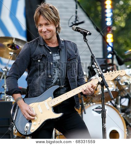 NEW YORK-JUL 11: Country music singer Keith Urban performs on ABC's 'Good Morning America' concert series at Rumsey Playfield, Central Park on July 11, 2014 in New York City.