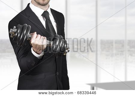 Businessman Weightlifting In Office