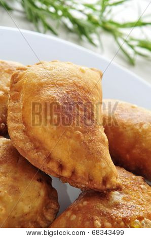 closeup of a plate with some spanish empanadillas, small meat or tuna pies, served as tapas