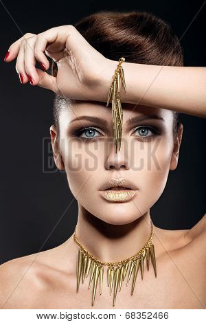 Beautiful girl with perfect skin and evening makeup.