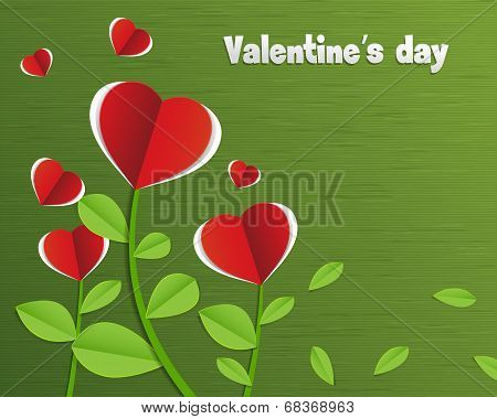 Red paper heart on paper green card.