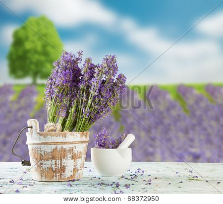 Harvested lavender flowers on wooden planks, blur field on background