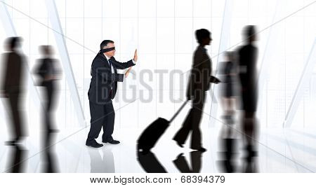 Mature businessman in a blindfold against white room with large window