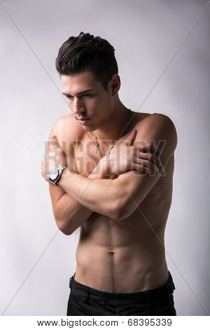Shirtless Young Man Hugging Himself