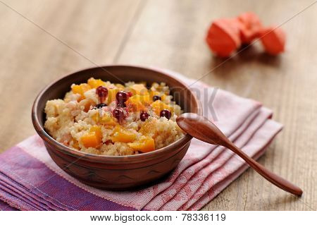 Millet Porrige With Pumpkin In Clay Bowl With Wooden Spoon