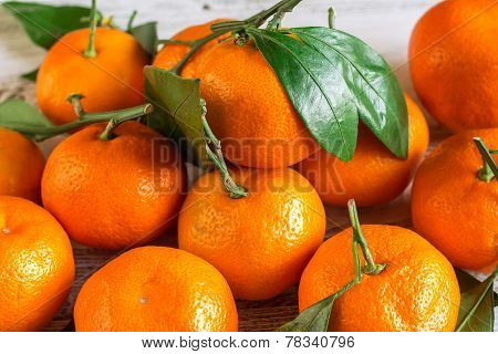 Tangerines With Leaves On A Wooden Table