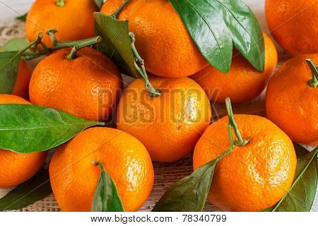 Tangerines With Leaves On A Wooden Table