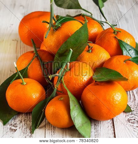 Tangerines With Leaves On A Wooden Table